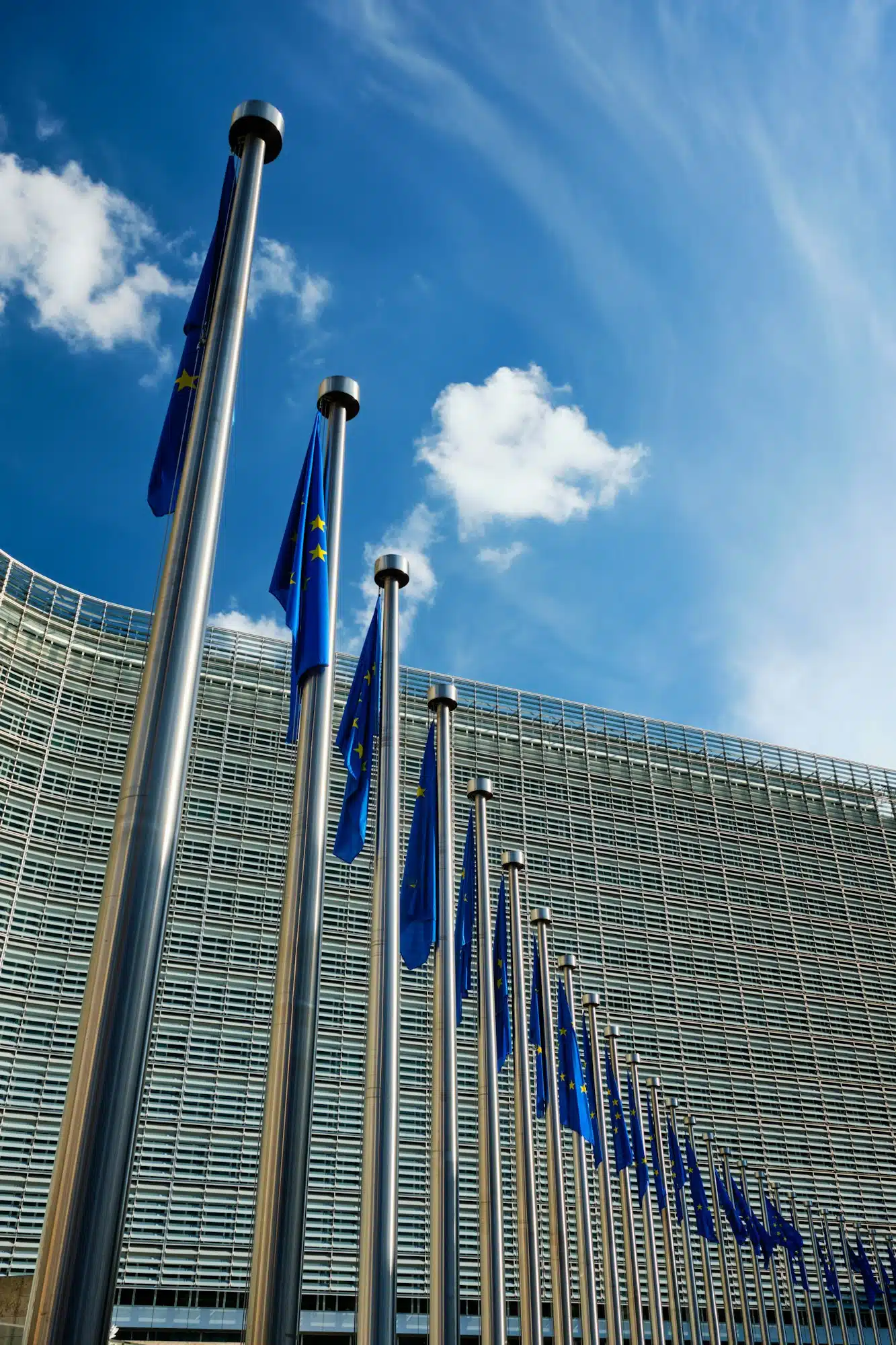 EU European Union flags in front of European Comission building in Background. Brussles, Belgium